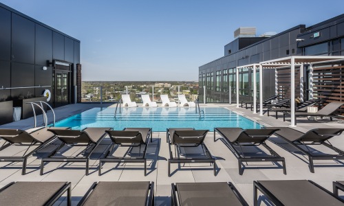 Resort-style swimming pool with lounge seating